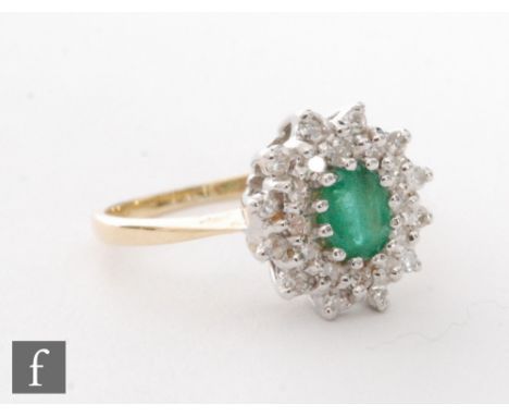 An 18ct emerald and diamond cluster ring, central emerald within a two row diamond border, weight 3g, ring size K 1/2. 