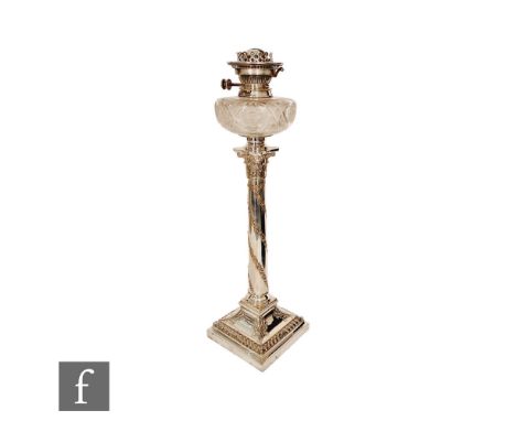 A Victorian silver plated oil lamp, the stepped square base with gadroon detail rising to a tapering column with floral decor