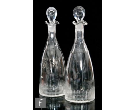 A pair of 19th Century glass decanters of club form, each with basal fluting and facet cut necks, one gilded SW for Scotch Wh