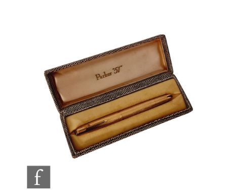 A cased 9ct hallmarked Parker 51 fountain pen with engine turned decoration and engraved initials A.F.D to cartouche, length 