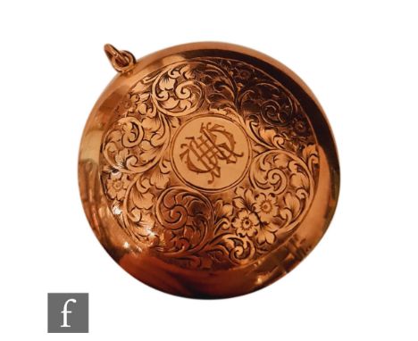 An early 20th Century 9ct rose gold circular compact with central initials within engraved foliate border, diameter 5cm, weig