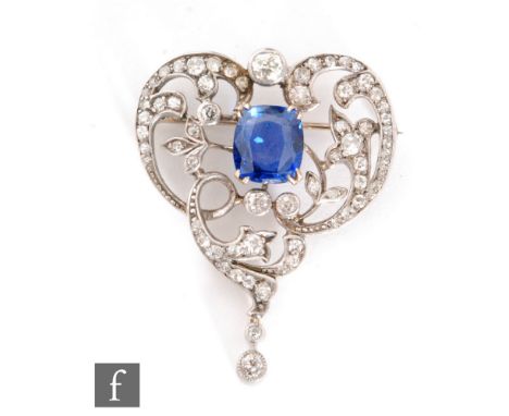 An early 20th Century sapphire and diamond open work brooch, central claw set cushioned sapphire length 10mm, within a diamon