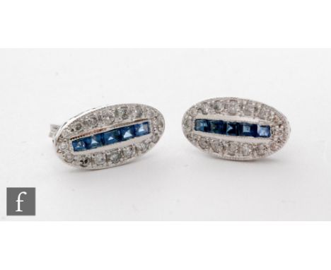 A pair of 18ct white gold sapphire and diamond stud earrings comprising a vertical channel set row of five square cut sapphir