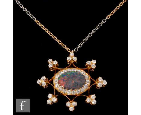 An early 20th Century black opal and diamond pendant, central oval opal, length 15mm, within an eighteen diamond set border a