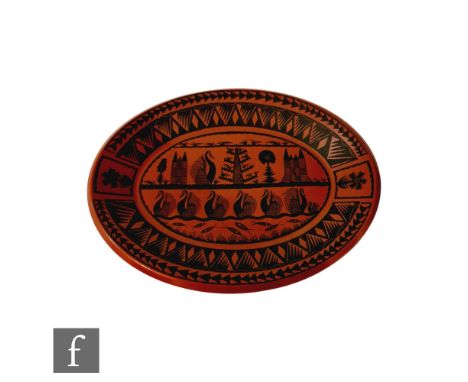 A Royal Worcester Crown Ware oval dish decorated with a design by Scottie Wilsons with stylised birds and buildings in black 