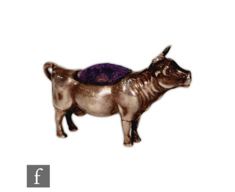 A silver hallmarked pin cushion modelled as a standing cow, Birmingham 1906, Levi &amp; Salaman, height 3.5cm, length 6cm, S/