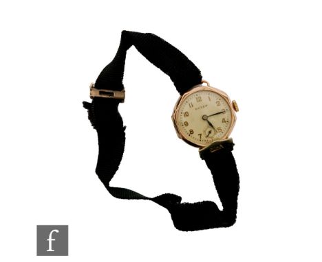 A lady's 9ct hallmarked Rolex manual wind wrist watch, Arabic numerals to a white dial within an octagonal case, diameter 24m