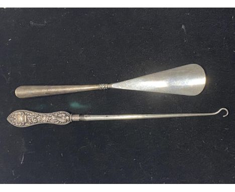 A Victorian hallmarked silver handled shoe horn and button hook 