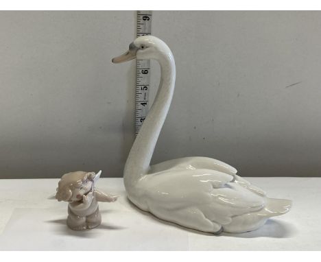 A Lladro Swan and a small Nao cherub 