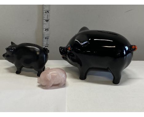 Two ceramic pig money boxes and a pink hardstone pig 