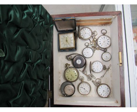 Eleven assorted pocket watches and a travel alarm clock, mostly late 19th Century silver cased examples. In a 19th Century ro