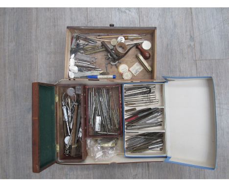 A collection of hand tools including needle and slotting files, pin vices, staking block, pliers, hammer, punches, drills etc