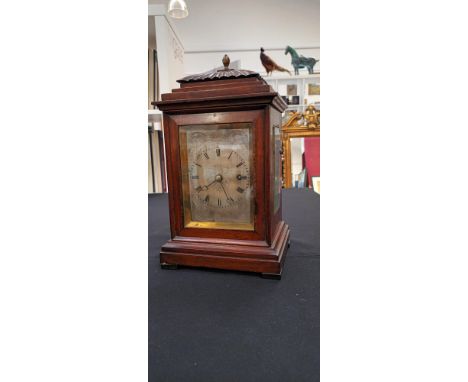 A 19th Century mahogany mantel timepiece, with black Roman numerals to the 9cm diameter chased silvered dial, the gut line on