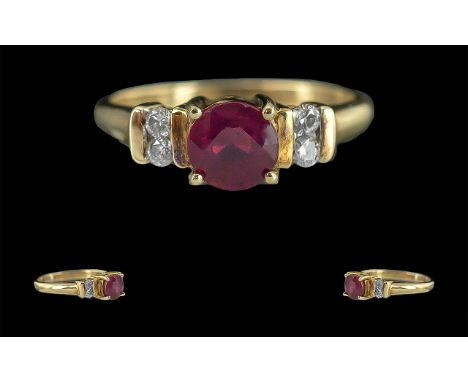 Ladies Contemporary 9ct Gold Ruby &amp; Diamond Set Dress Ring.  Full hallmark to interior of shank.  The central Ruby of goo