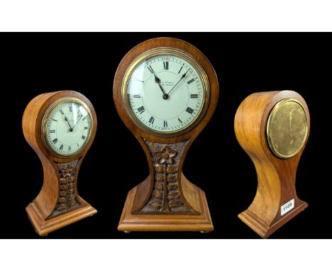 Edwardian Balloon Shaped Mantle Clock, enamel dial with Roman numerals and carved flower to body.  Key wind movement.  Ticks 