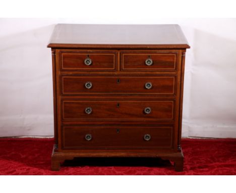 Victorian mahogany and inlaid small chest of two short over three long drawers, the shaped pillar columns raised on bracket s