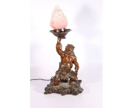 A Japanese model of an oni, holding aloft a frosted pink and white flame lantern, fitted for electricity, the oni is kneeling