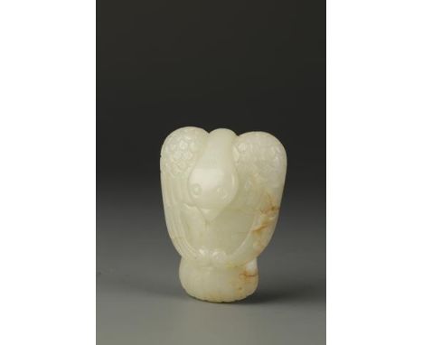 A CHINESE PALE CELADON AND RUSSET JADE PHOENIX, the stylised creature with finely detailed feathers and its' head turned to t