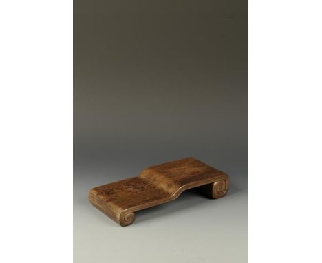 A CHINESE JICHIMU STAND of asymmetric scroll form with two tiers, Qing, 19th century, 15" (38cm) long Provenance: The collect