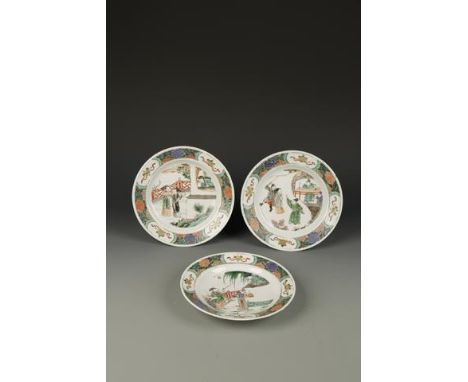THREE CHINESE FAMILLE VERTE SAUCER DISHES decorated with narrative figure scenes, Kangxi, 8.5" (21.5cm) dia. (3)