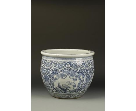 A CHINESE BLUE AND WHITE JARDINIERE decorated with ogee panels and roundels on a foliate scroll ground, late Qing, 14.5" (37c