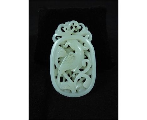 A Chinese white jade carving, decorated with an exotic bird amongst scrolling foliage, 6 x 3.5 x 1cm.