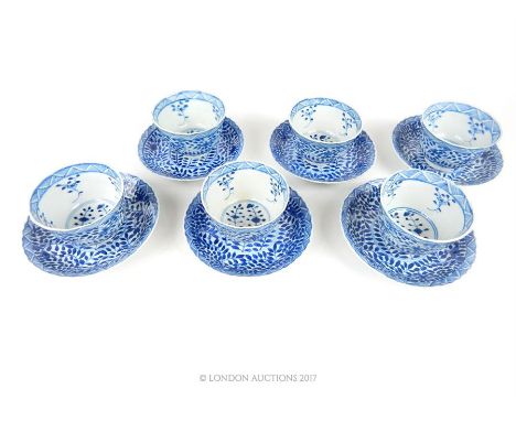 A set of six Chinese Ming style blue and white porcelain tea bowls and saucers, decorated with floral decoration, bearing fou