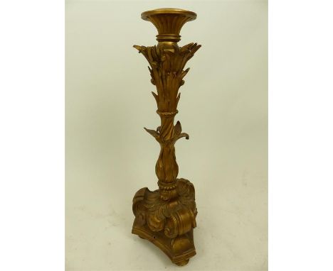 A late 19th century gilt metal standard lamp base adorned with twisting foliage and berries, scrolls and cartouches and termi