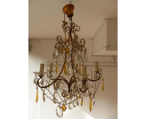 An early 20th century gilt metal and cut glass five light chandelier, hung with swagged chains and clear and amber drops. 