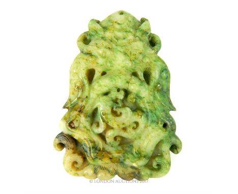 A Chinese carved jade pendant in the form of a mythical creature with a serpent between its jaws, 8 x 6 x 1cm.