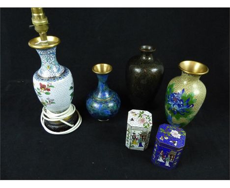 A collection of six Chinese cloisonne items, including a lamp on a carved wooden stand, three vases and two boxes with covers