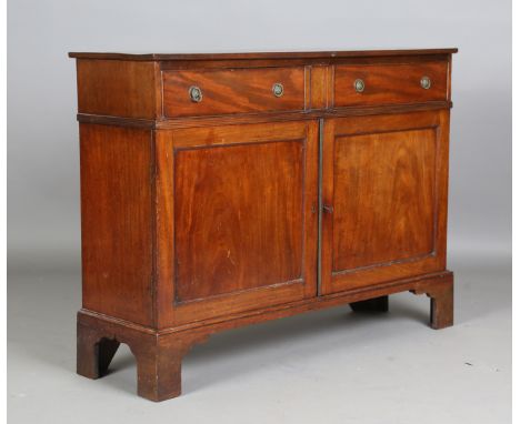 A late 19th/early 20th century George III style mahogany side cabinet, fitted with two oak-lined drawers above a pair of door