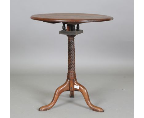 A George III and later mahogany tip-top wine table, fitted with a birdcage mount above a spiral fluted stem and tripod legs, 