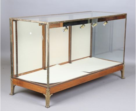 A mid-20th century walnut and brass framed shop counter display unit, raised on cast gilt metal acanthus leaf feet, height 91