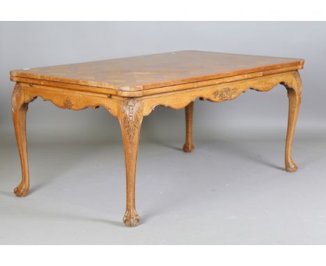 A 20th century French oak parquetry draw-leaf dining table, raised on carved cabriole legs, height 75cm, extended length 274c