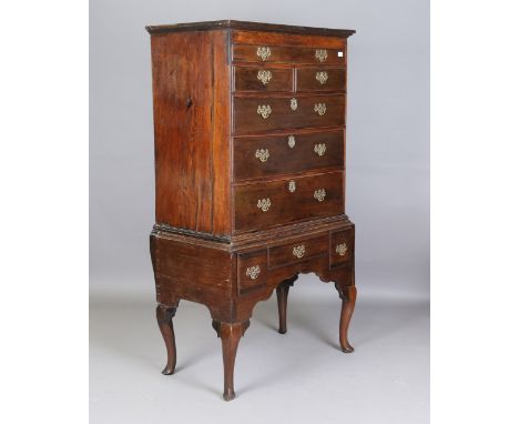 A late 18th century provincial oak chest-on-stand, fitted with an arrangement of drawers, on pointed pad feet, height 180cm, 
