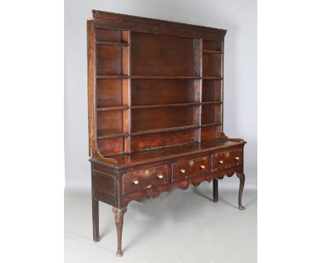 A George III provincial oak dresser, the shelf back above three crossbanded drawers, on cabriole legs, height 215cm, width 19