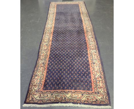 A Serrabend runner, North-west Persia, late 20th century, the blue field with overall boteh, within an ivory border, 320cm x 