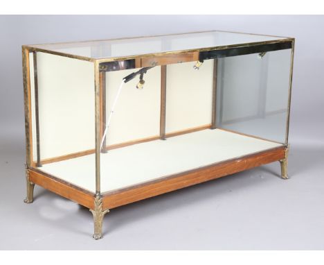 A mid-20th century walnut and brass framed shop counter display unit, raised on cast gilt metal acanthus leaf feet, height 91