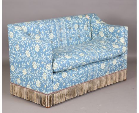 A modern two-seat settee, finely upholstered in foliate patterned fabric with deep cushion and long fringed apron, height 90c