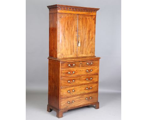 A George III mahogany secrétaire bookcase, the associated top and base with crossbanded borders, the secrétaire drawer fitted