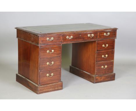 A late 19th/early 20th century walnut twin pedestal desk, the green leather top above an arrangement of drawers, height 71cm,