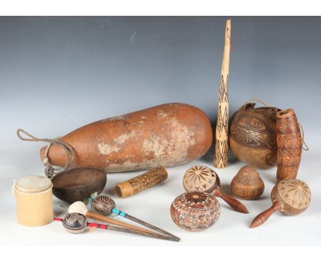 A collection of ethnic items, including gourds, some with incised and painted decoration, maracas and other musical items, to