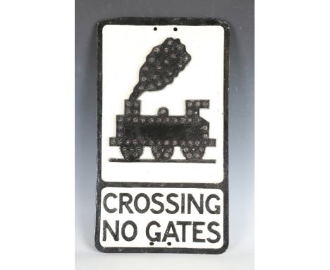 A cast alloy railway 'Crossing No Gates' sign, the outline of the locomotive inset with reflectors, detailed 'Royal Label Fac