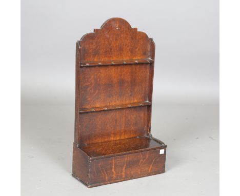 An 18th century oak mural spoon rack with shaped back and candlebox to base, height 57cm, width 33cm, depth 13cm.Buyer’s Prem