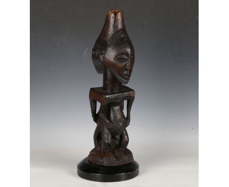 A Hemba people carved wooden Singiti ancestor figure, Democratic Republic of Congo, both sides modelled with swollen stomachs