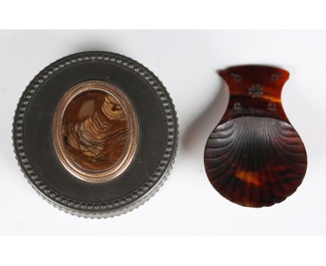 An early 19th century papier-mâché circular snuff box, modelled to imitate metal studded construction, the lid inset with a s