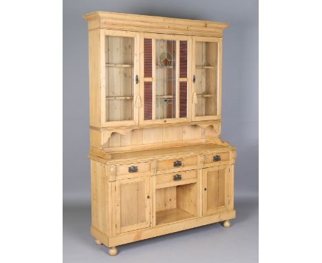 A 20th century pine kitchen dresser, the glazed top with a fixed stained glass panel, the base fitted with drawers and cupboa