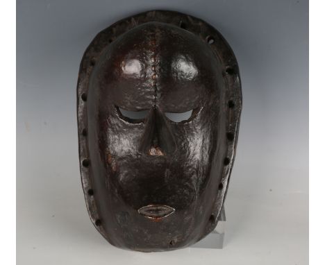 A Central African carved hardwood mask with deep, rich brown surface patina, length 27cm.Buyer’s Premium 29.4% (including VAT