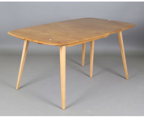 An Ercol pale elm extending dining table, fitted with two extra leaves, height 71cm, extended length 227cm, depth 90cm.Buyer’